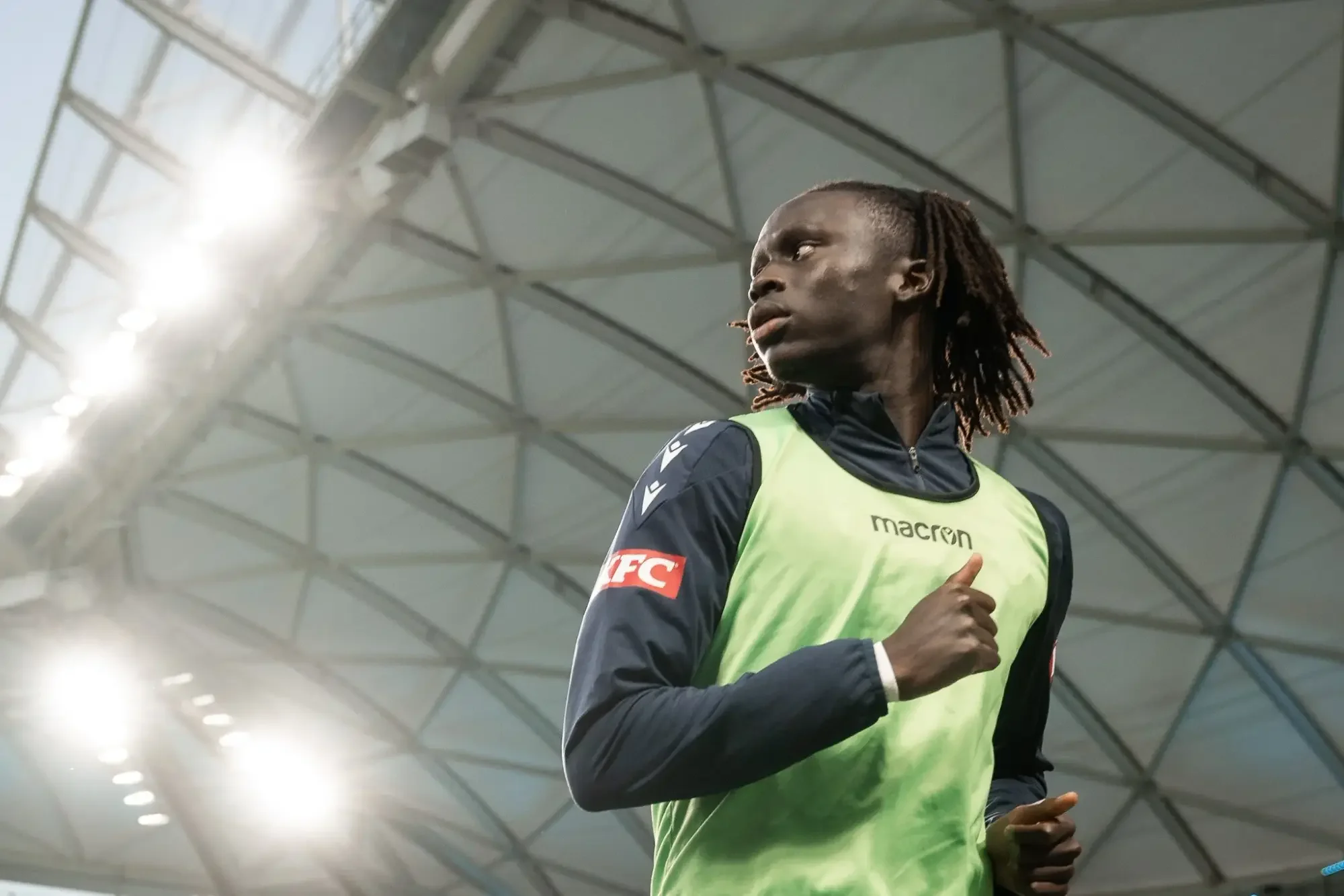 Goalkeeper beneath the stadium roof