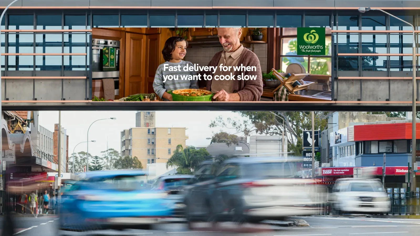 Woolworths delivery advertising above a busy street
