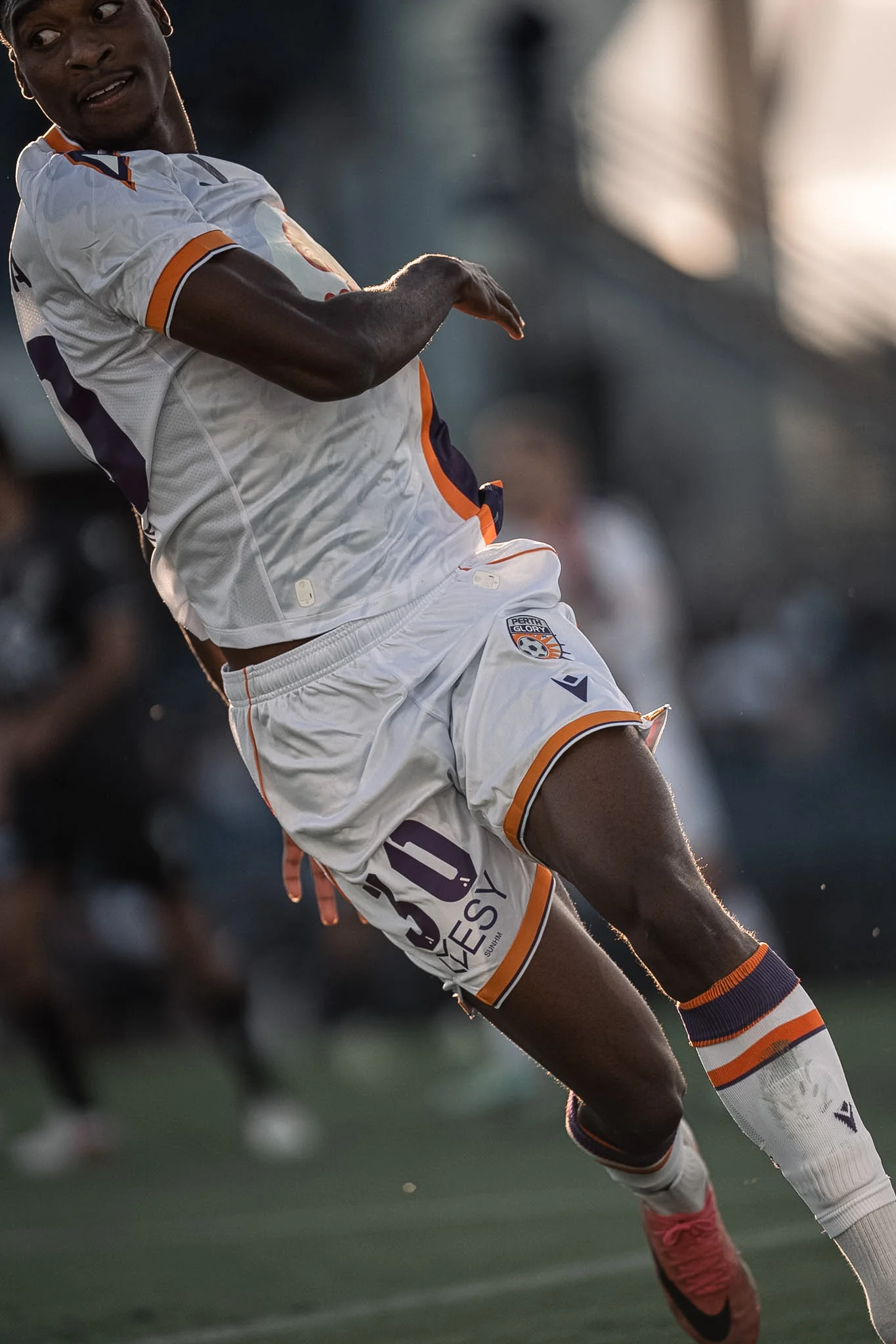 Player in a white shirt on the pitch