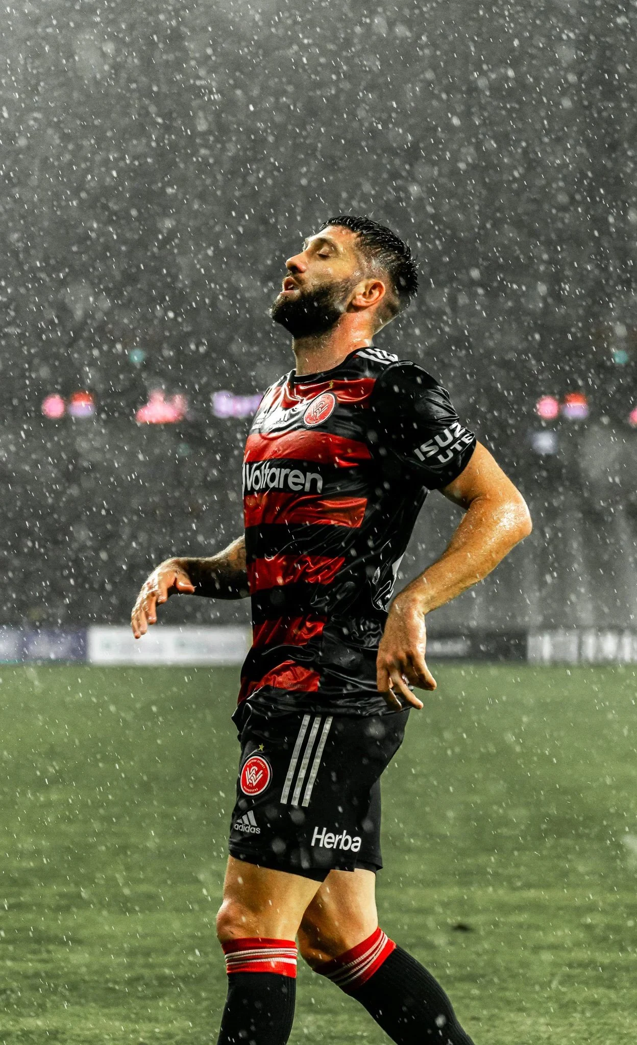 Player standing in the rain on the pitch