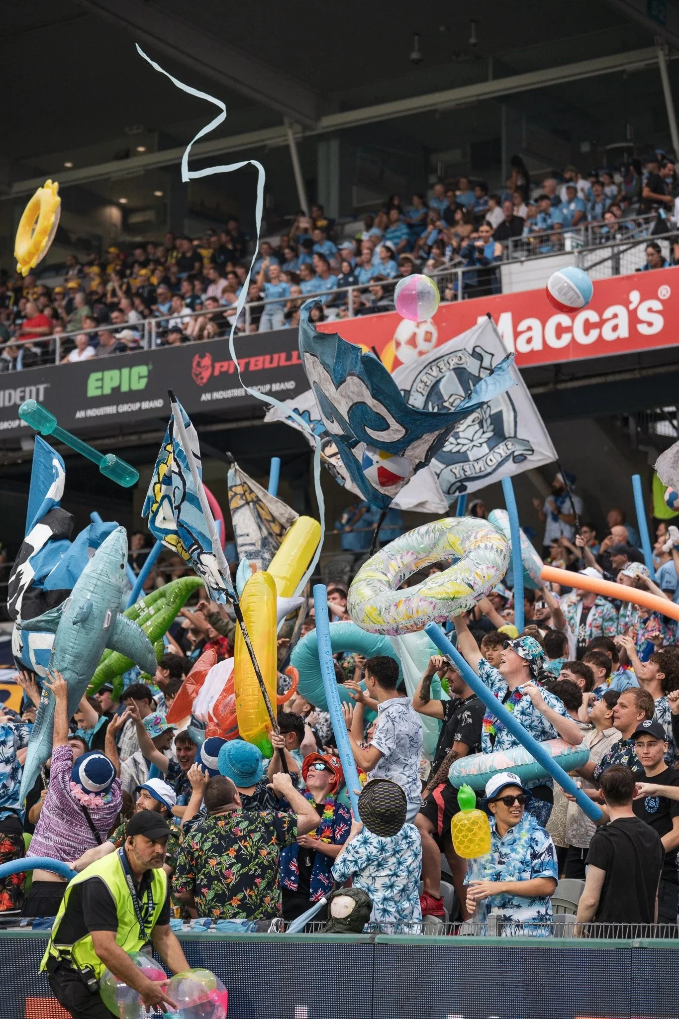 Crowd celebrating with inflatables and flags