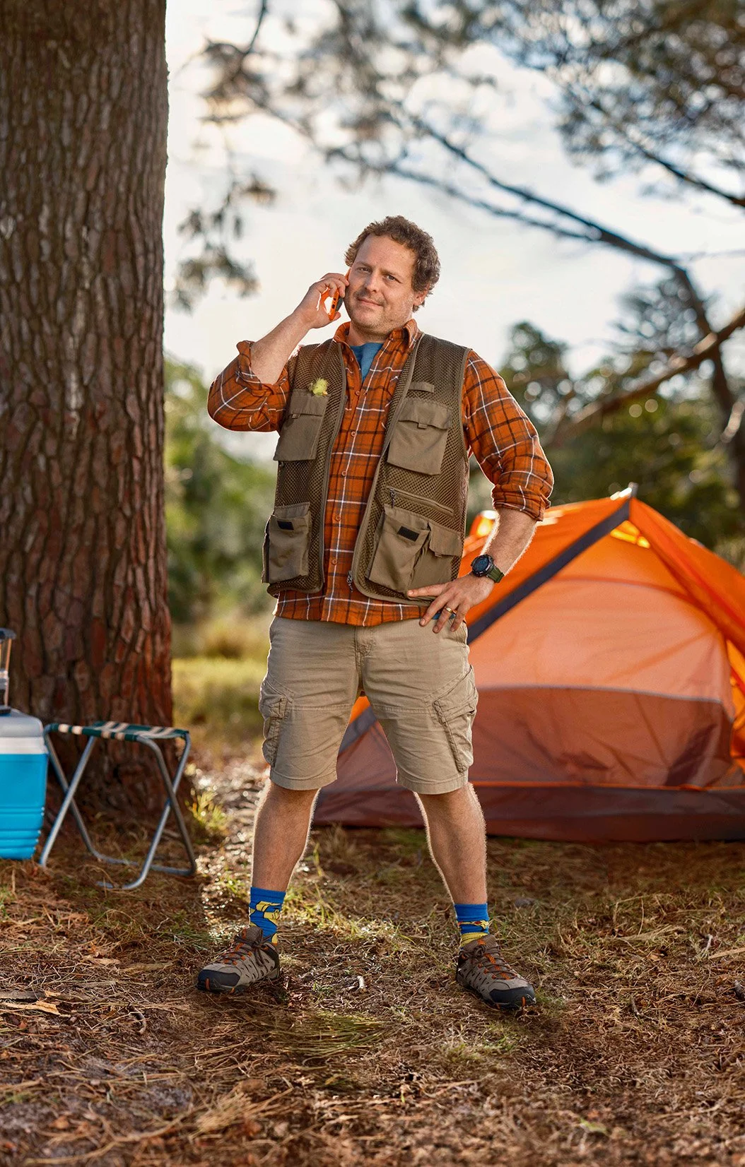 Everyday Mobile lifestyle photography of a camper beside an orange tent